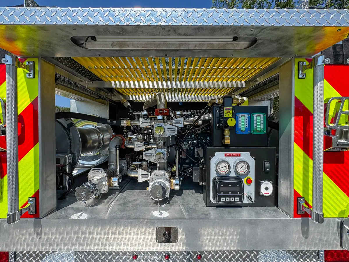 Rear pump panel close-up with gauges, switches, and labeled controls.